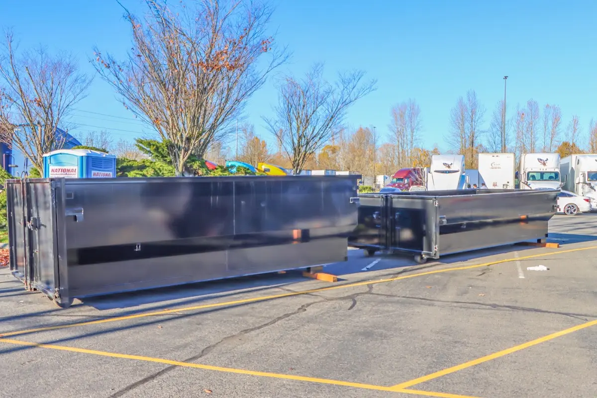 Professional dumpster rental service with roll-off container on residential driveway in Miami Gardens